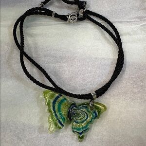NWT glass butterfly amulet with 24 in long black braid